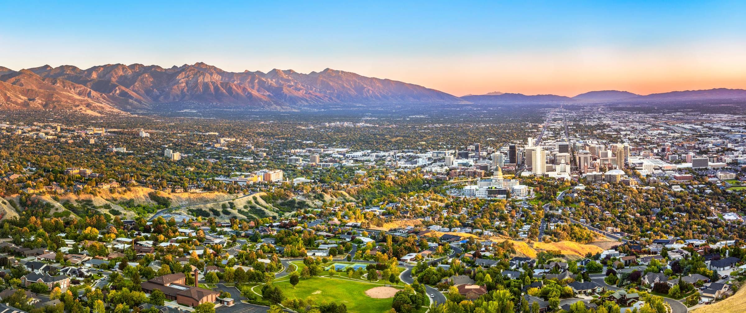 Montaire Student Living Apartments Aerial view of Salt Lake City with the Wasatch Mountains in the background during sunset.