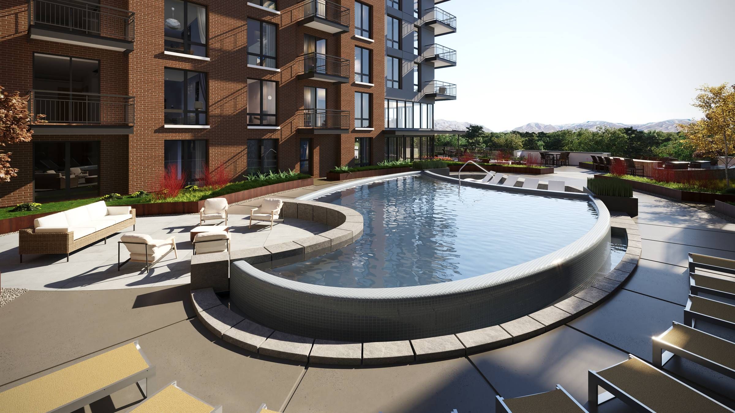 Montaire Student Living Apartments Curved outdoor pool with lounge chairs and seating area beside a modern apartment building.